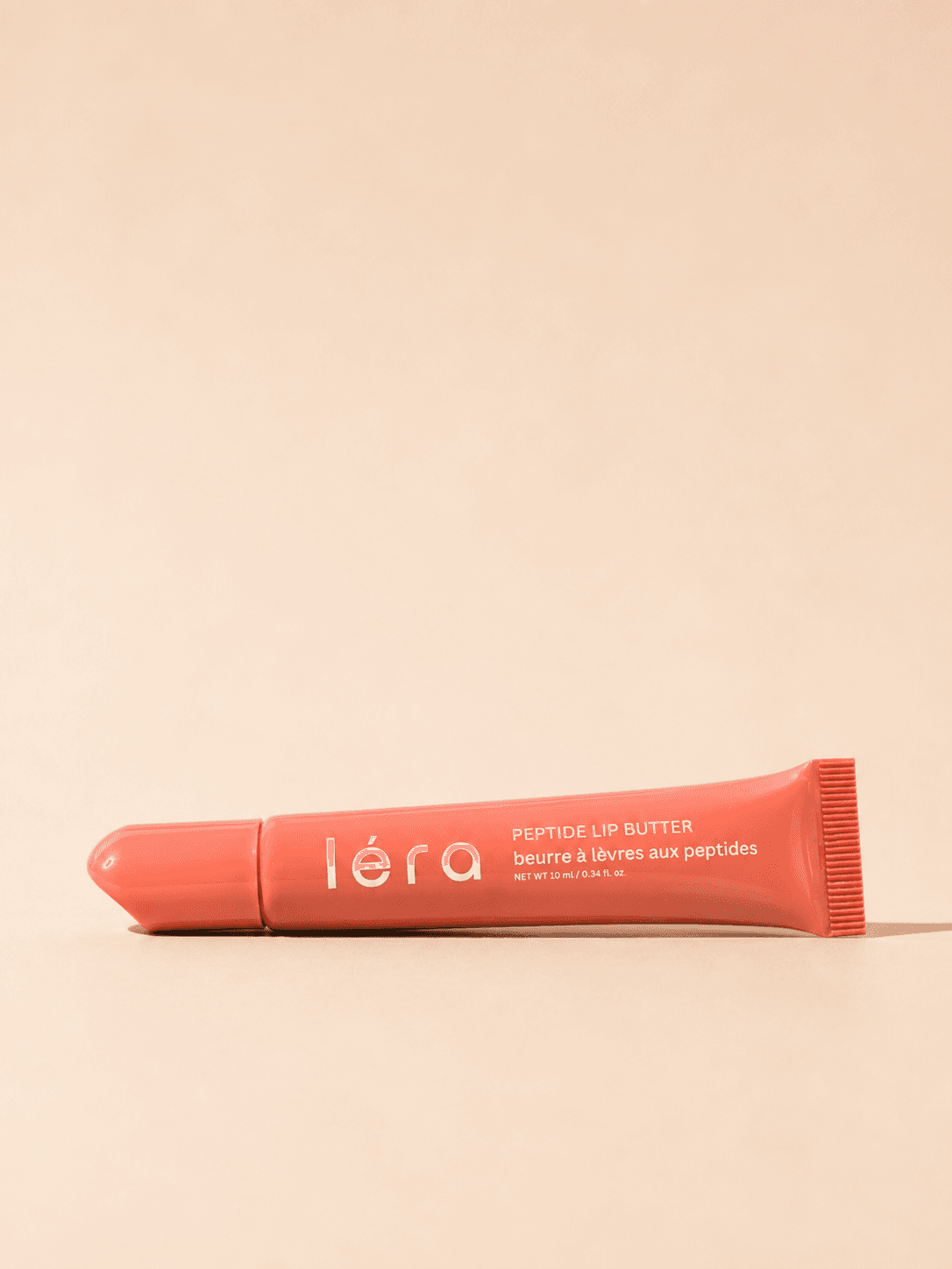 LÉRA Peptide Lip Butter on a warm, sunlit surface