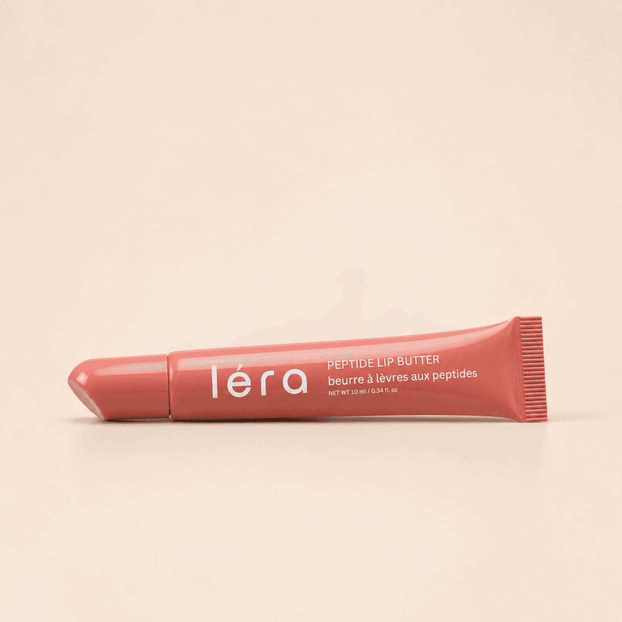 LÉRA Peptide Lip Butter on a warm, sunlit surface