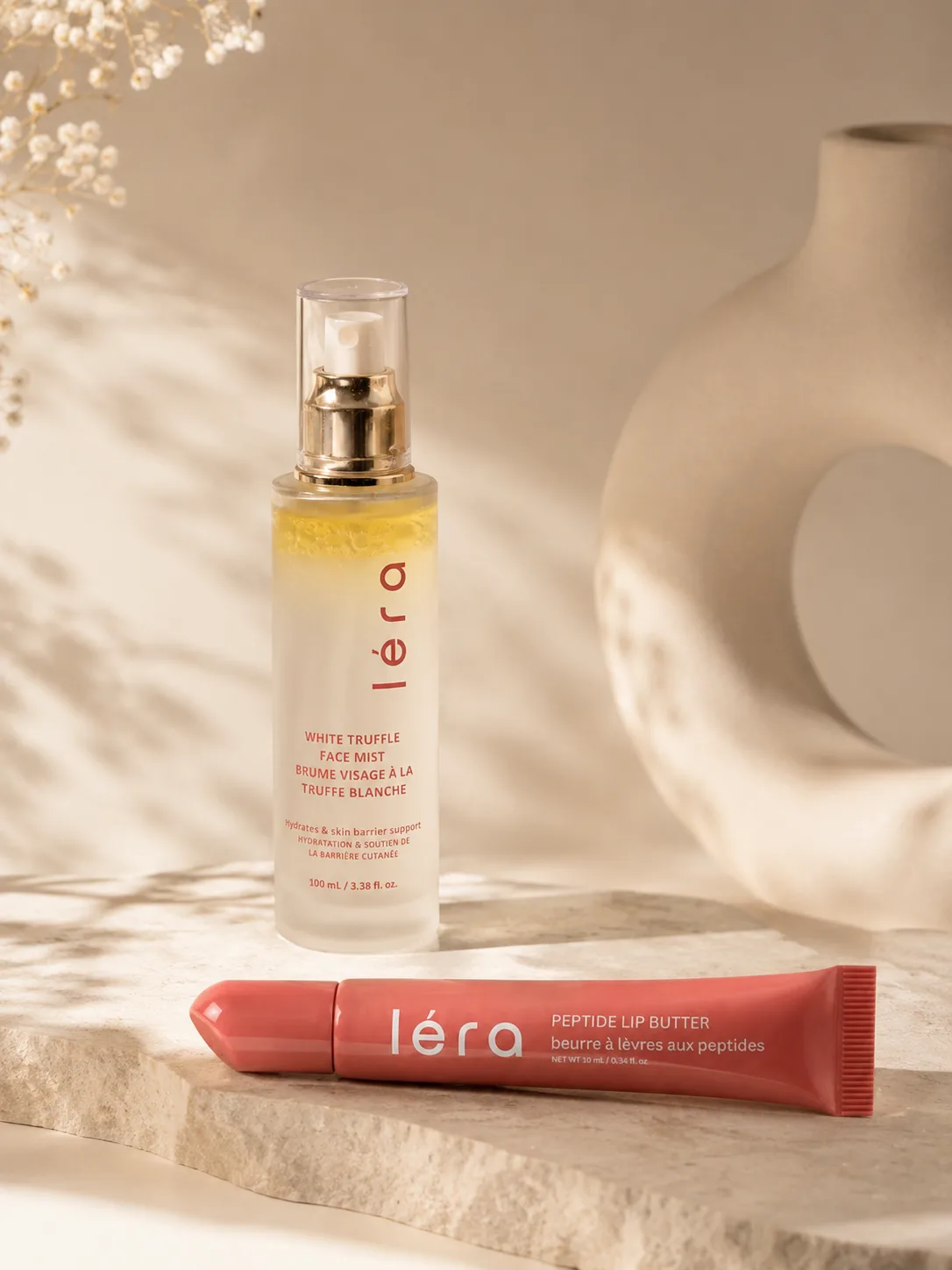 LÉRA White Truffle Face Mist and Peptide Lip Butter styled on stone